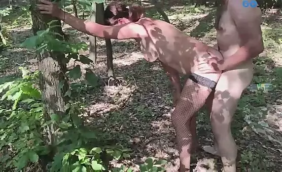 Wild couple enjoying outdoor sex in the forest